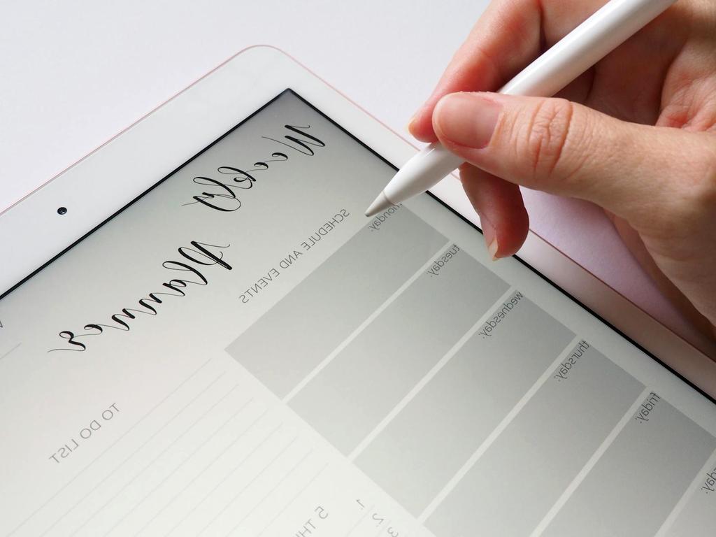 Office desk with computer, phone, and organized digital workspace